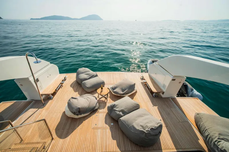  Yacht Photos Pics Luxurious 2024 Sanlorenzo SX100 yacht deck with bean bags, overlooking serene ocean view.