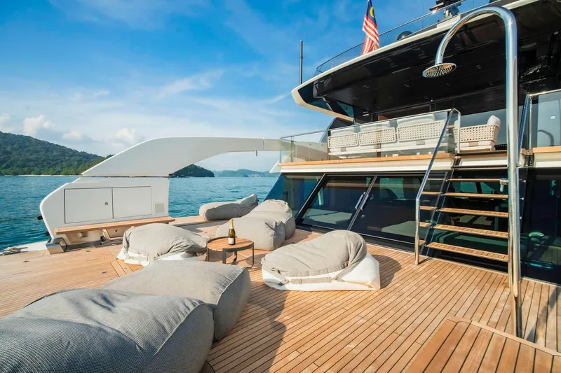  Yacht Photos Pics Luxurious 2024 Sanlorenzo SX100 yacht deck with plush seating and ocean view.