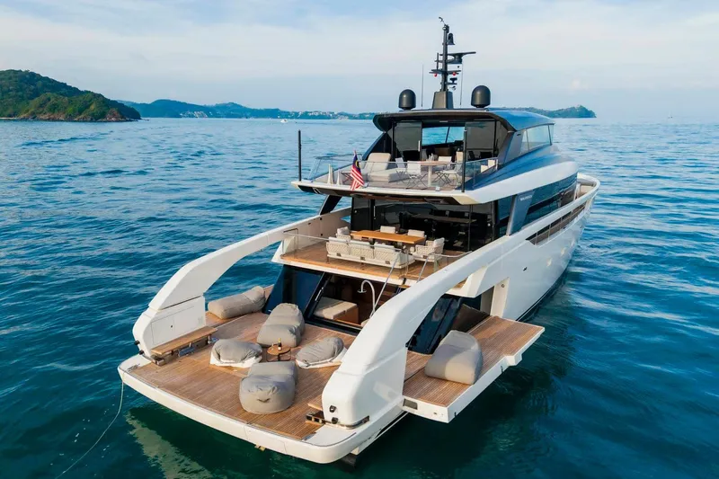  Yacht Photos Pics 2024 Sanlorenzo SX100 yacht on serene ocean waters, showcasing luxurious design and spacious deck.