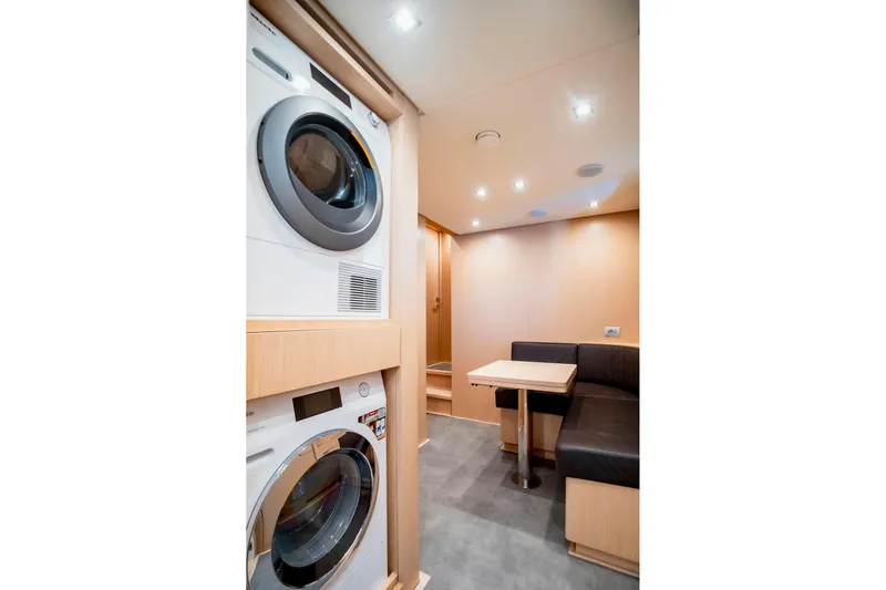  Yacht Photos Pics Laundry area and seating in 2024 Sanlorenzo SX100 yacht interior.