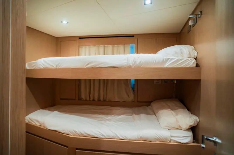  Yacht Photos Pics 2024 Sanlorenzo SX100 yacht cabin with wooden bunk beds and soft lighting.