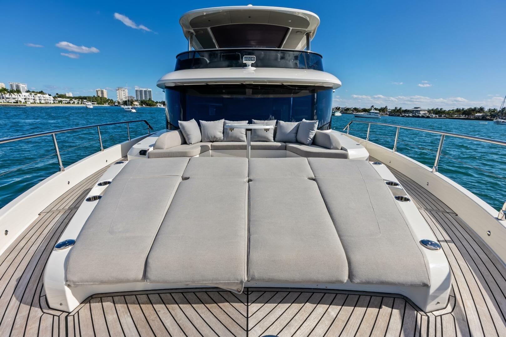 Luxurious 2025 Absolute 75 Navetta yacht with spacious sun deck on open water.