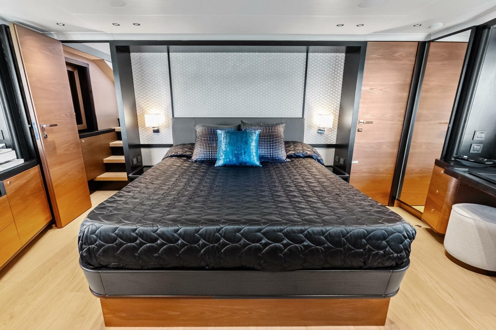 Luxurious bedroom interior of 2025 Absolute 75 Navetta yacht with modern design elements.