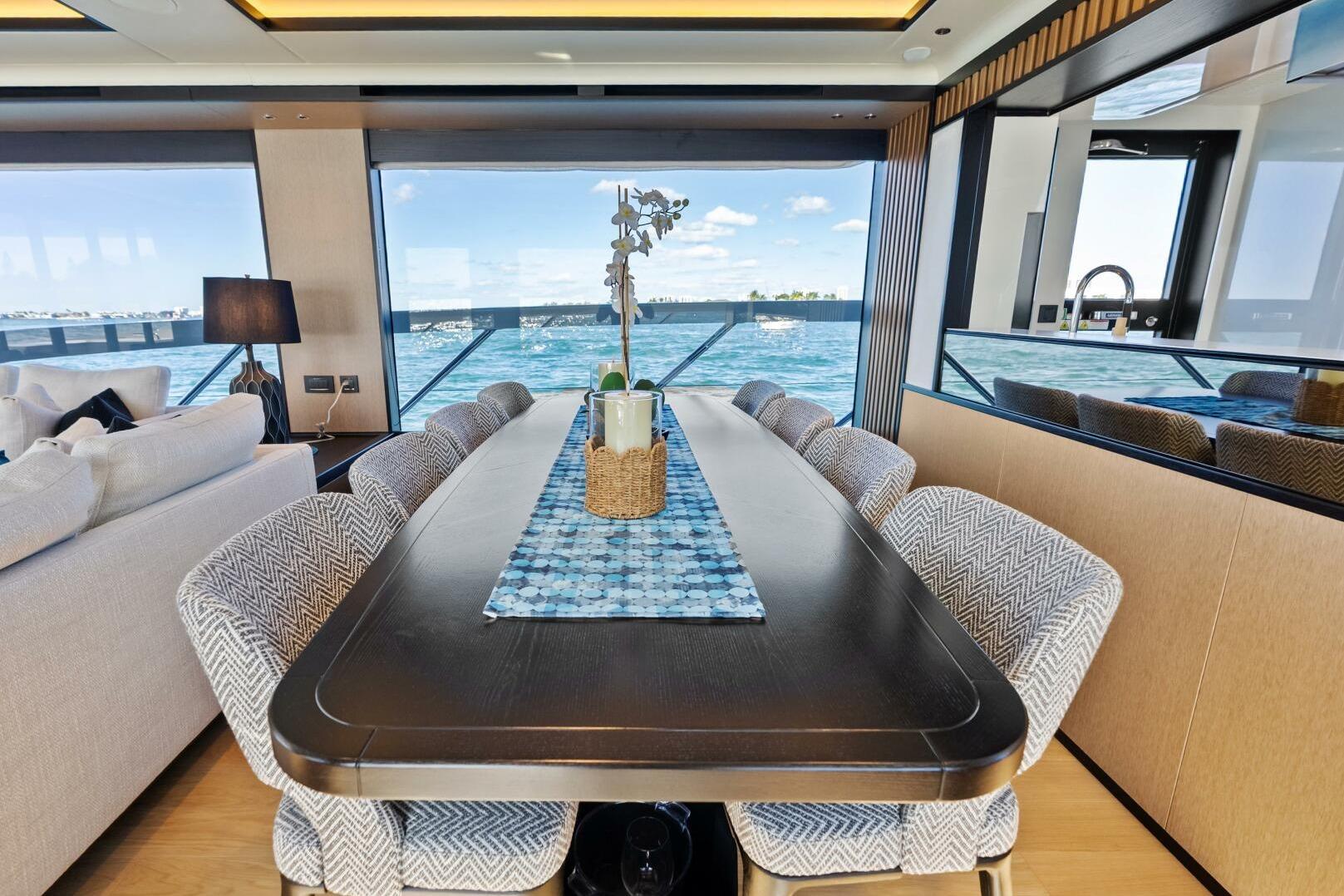 Luxurious dining area on 2025 Absolute 75 Navetta yacht with ocean view.