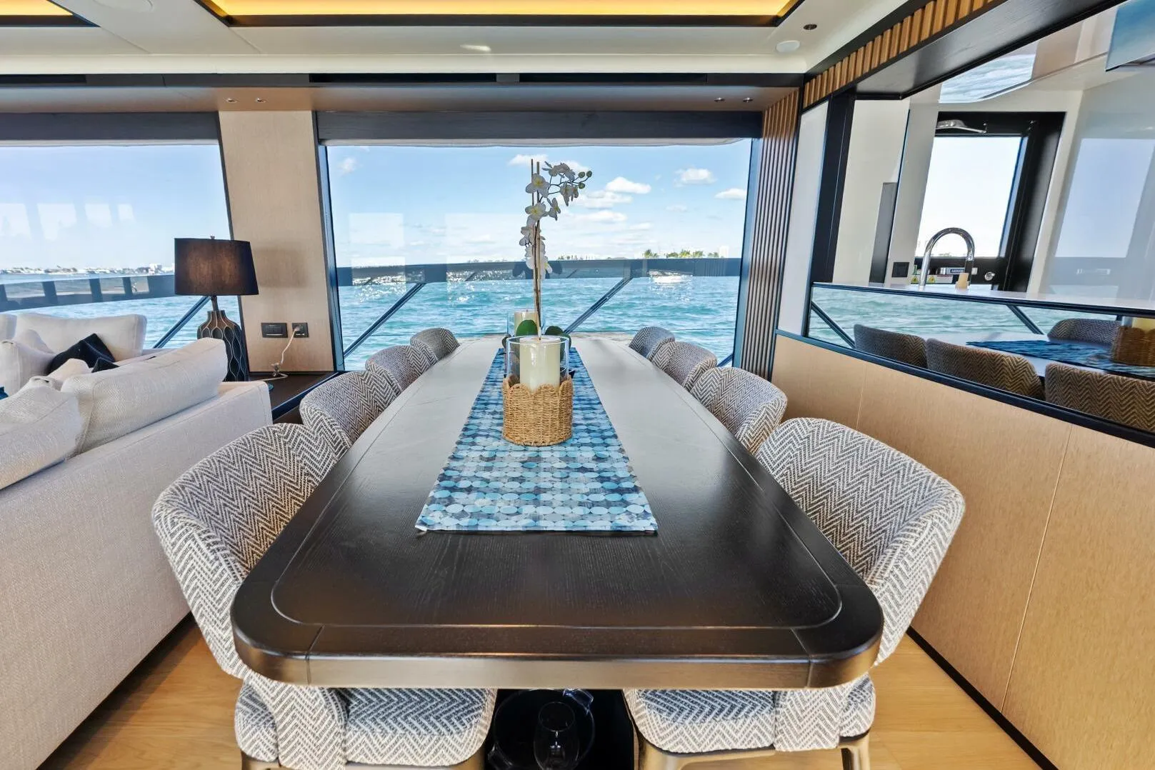Luxurious dining area on 2025 Absolute 75 Navetta yacht with ocean view.