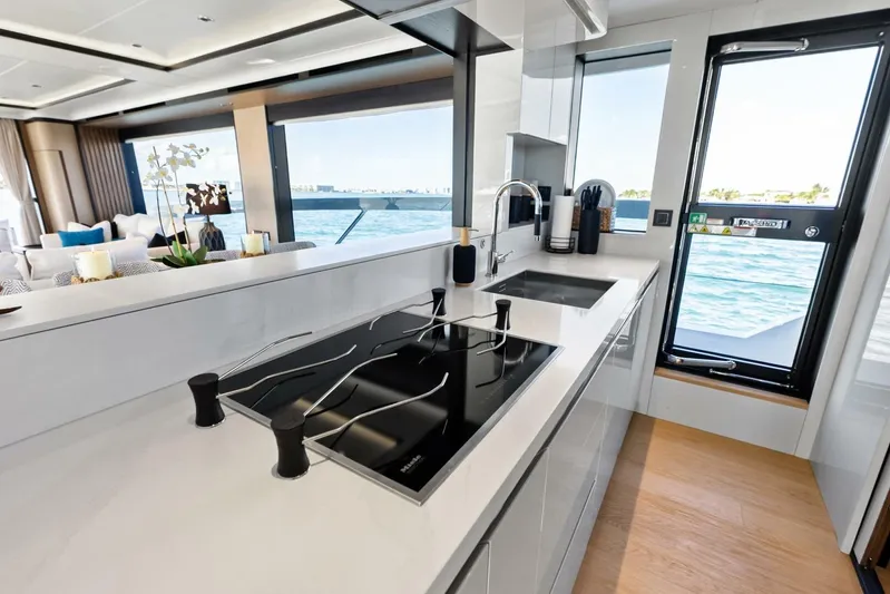 Fantasy Girl Yacht Photos Pics Luxurious kitchen interior of 2025 Absolute 75 Navetta yacht with ocean view.