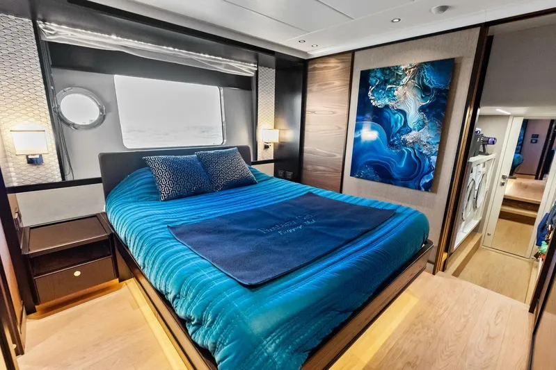Fantasy Girl Yacht Photos Pics Luxurious bedroom interior of 2025 Absolute 75 Navetta yacht with modern decor and blue accents.