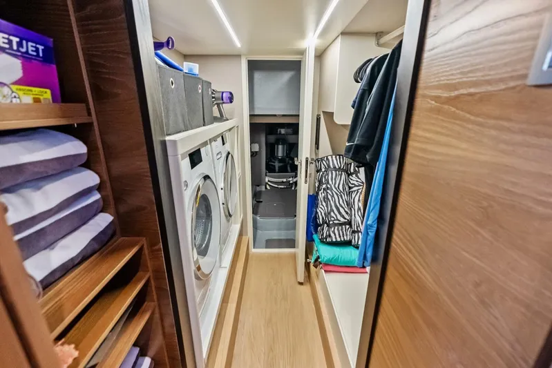 Fantasy Girl Yacht Photos Pics Laundry room on Absolute 75 Navetta yacht, featuring washer, dryer, and storage shelves, 2025 model.