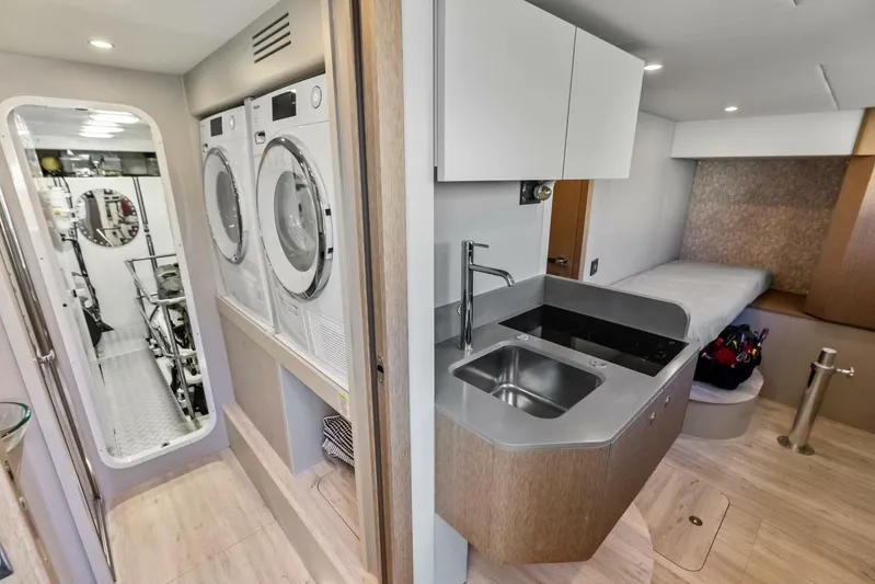 Fantasy Girl Yacht Photos Pics Laundry and kitchenette area on 2025 Absolute 75 Navetta yacht, featuring modern appliances and sleek design.
