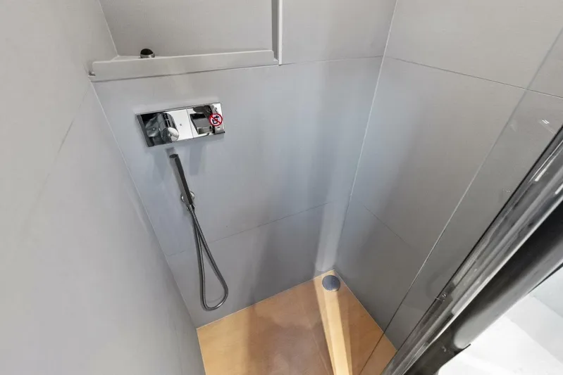 Fantasy Girl Yacht Photos Pics Shower area in 2025 Absolute 75 Navetta yacht with modern fixtures and wooden flooring.