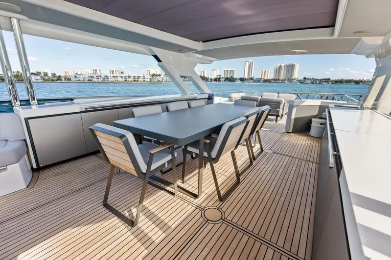 Fantasy Girl Yacht Photos Pics Luxurious deck of 2025 Absolute 75 Navetta yacht with modern dining area.