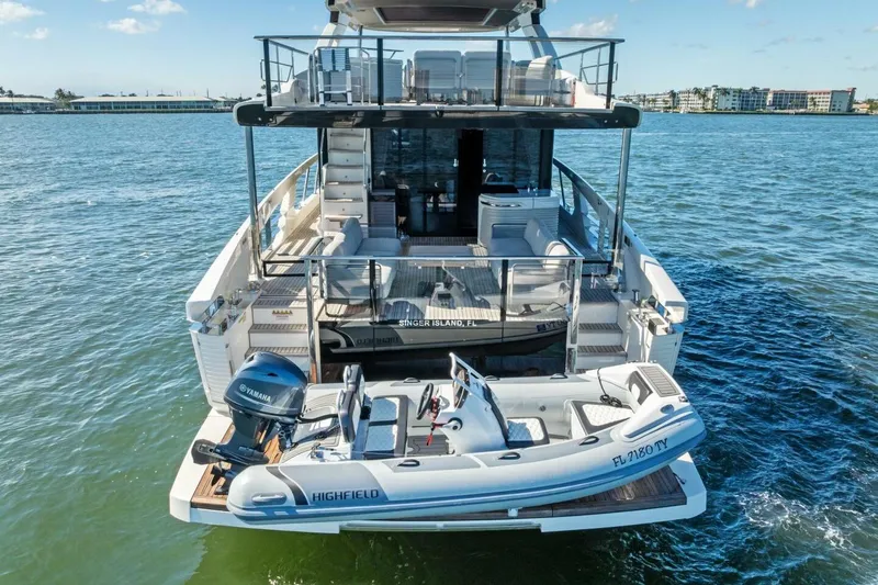 Fantasy Girl Yacht Photos Pics Luxury Absolute 75 Navetta yacht, 2025 model, with tender boat on water.