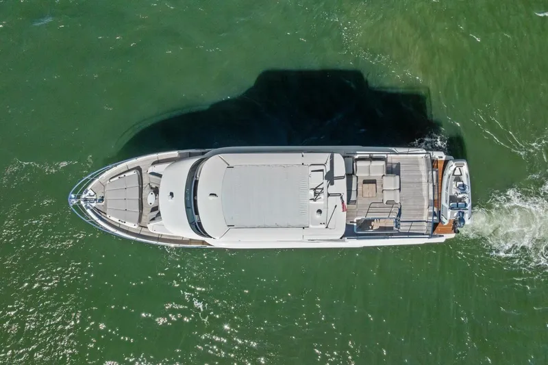 Fantasy Girl Yacht Photos Pics Aerial view of 2025 Absolute 75 Navetta yacht cruising on green water.