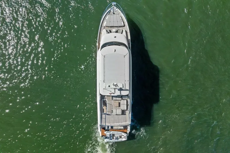 Fantasy Girl Yacht Photos Pics Aerial view of 2025 Absolute 75 Navetta yacht cruising on green water.