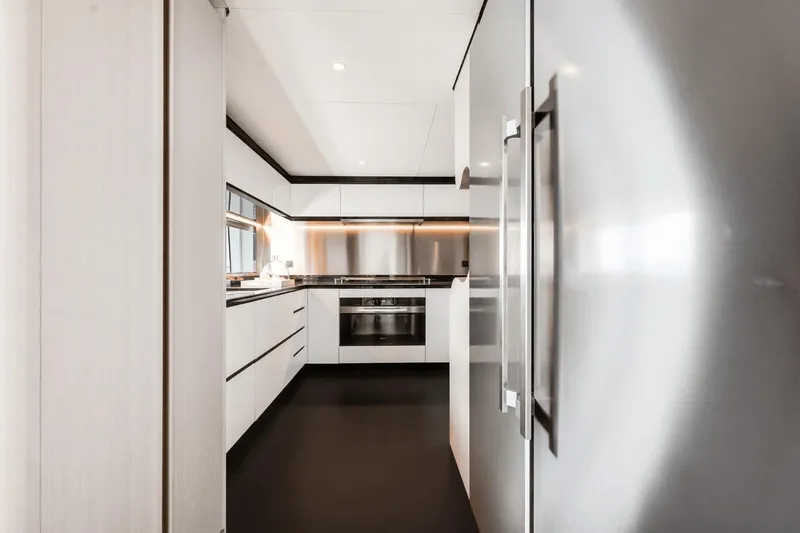  Yacht Photos Pics Modern kitchen interior on 2025 Azimut Grande 36M yacht, featuring sleek cabinetry and stainless steel appliances.
