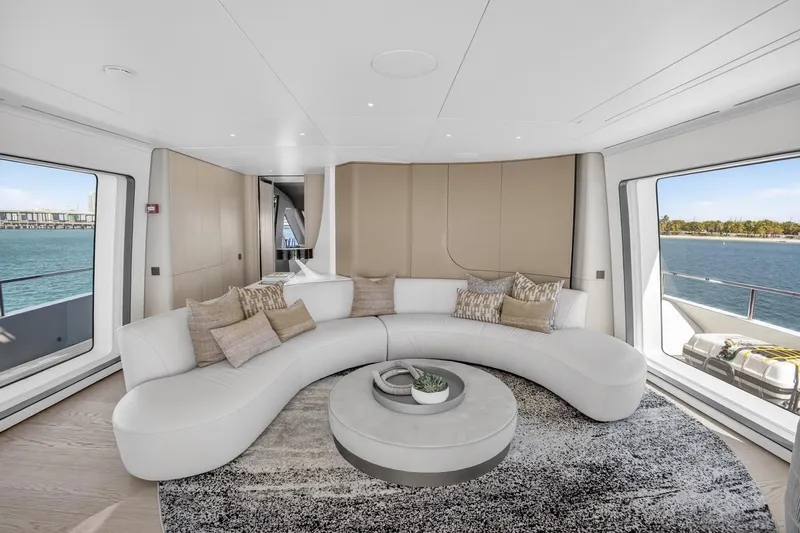  Yacht Photos Pics Luxurious interior of 2025 Azimut Grande 36M yacht with elegant curved sofa and sea view.