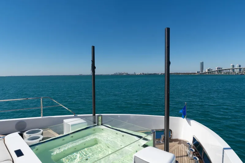  Yacht Photos Pics Azimut Grande 36M 2025 yacht with jacuzzi, ocean view, and city skyline.