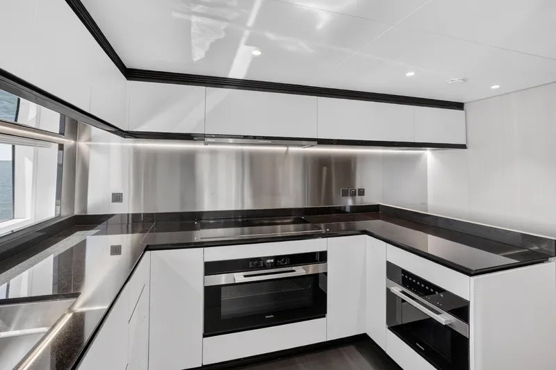  Yacht Photos Pics Modern kitchen interior on 2025 Azimut Grande 36M yacht, featuring sleek design and high-end appliances.