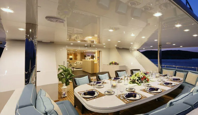  Yacht Photos Pics Luxurious dining area on 1987 Benetti 50 CUSTOM yacht, elegantly set for an evening meal.