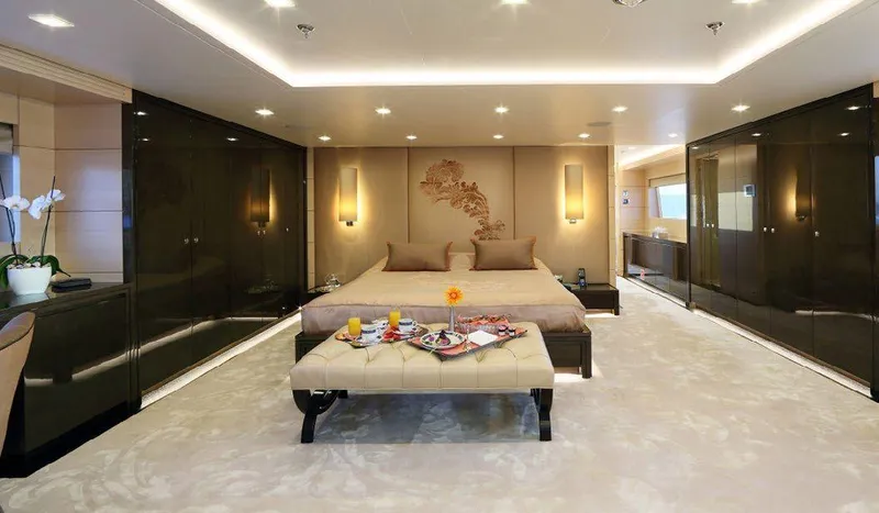  Yacht Photos Pics Luxurious bedroom interior on 1987 Benetti 50 CUSTOM yacht, featuring elegant decor and modern amenities.