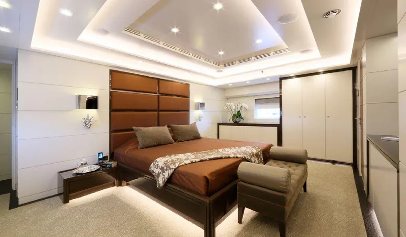  Yacht Photos Pics Luxurious bedroom interior on 1987 Benetti 50 CUSTOM yacht, featuring elegant design and ambient lighting.