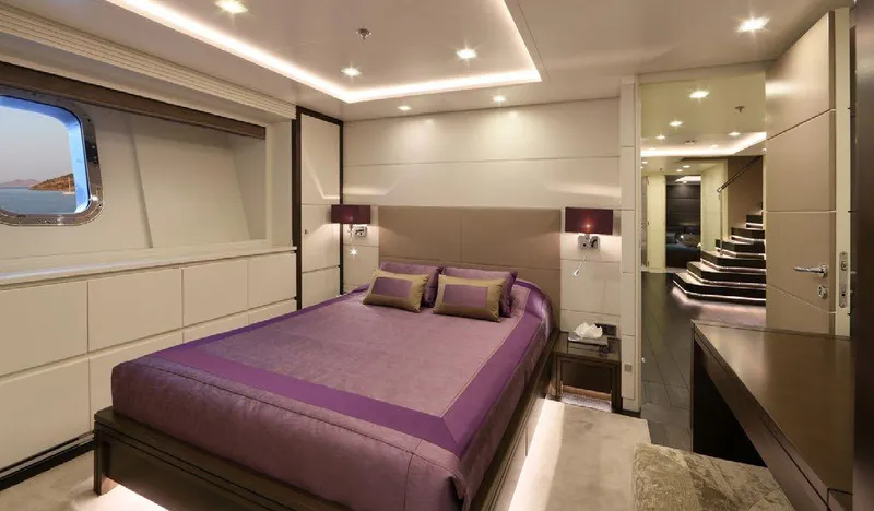  Yacht Photos Pics Luxurious bedroom interior on 1987 Benetti 50 CUSTOM yacht with elegant purple bedding.