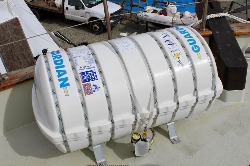 Hawaiian Chieftain Yacht Photos Pics Life raft on 1988 Lahaina Welding Co. Square Topsail Ketch deck, labeled "Guardian."