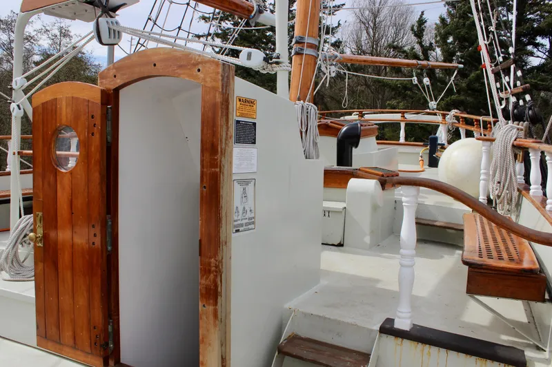 Hawaiian Chieftain Yacht Photos Pics 1988 Custom Lahaina Welding Co. Square Topsail Ketch deck with wooden details and open cabin door.