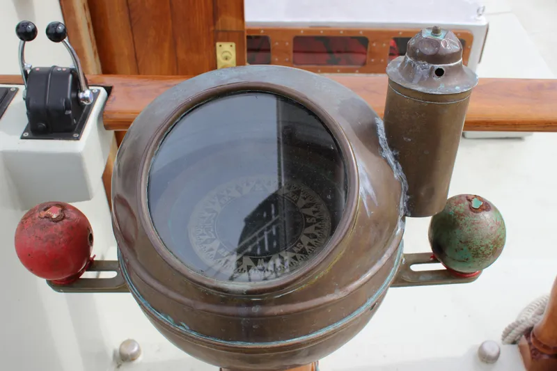 Hawaiian Chieftain Yacht Photos Pics Vintage compass on 1988 Lahaina Welding Co. Square Topsail Ketch, featuring nautical design elements.