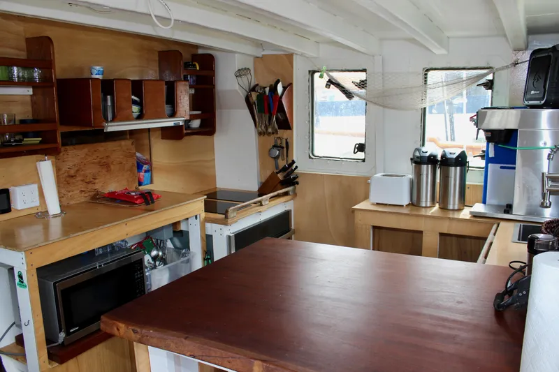 Hawaiian Chieftain Yacht Photos Pics Interior of 1988 Custom Lahaina Welding Co. Square Topsail Ketch with kitchen amenities.