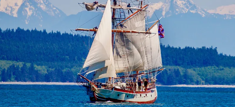 Hawaiian Chieftain Yacht Photos Pics A 1988 Custom Lahaina Welding Co. Square Topsail Ketch sailing with mountains in the background.