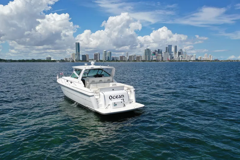  Yacht Photos Pics 1999 Tiara Yachts 4000 Express on water with city skyline in background.