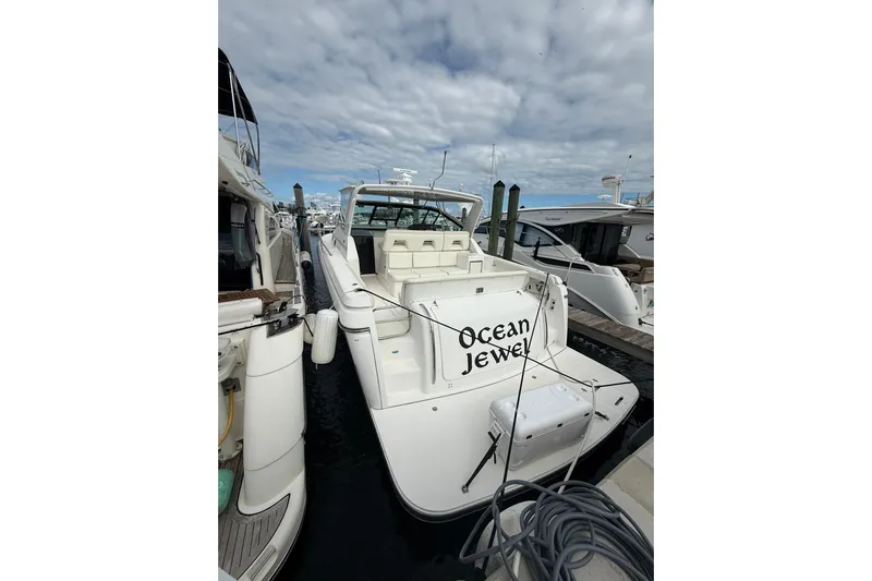  Yacht Photos Pics 1999 Tiara Yachts 4000 Express "Ocean Jewel" docked at marina under cloudy sky.