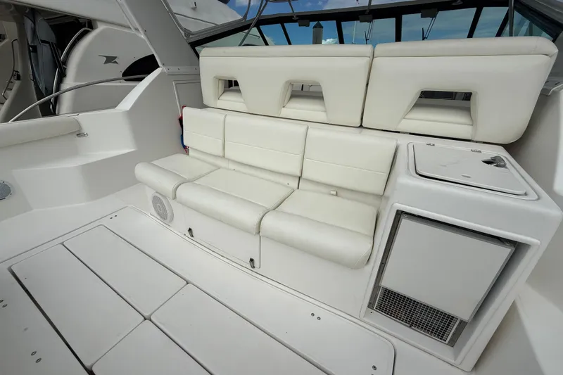  Yacht Photos Pics 1999 Tiara Yachts 4000 Express interior with white seating and compact kitchenette.