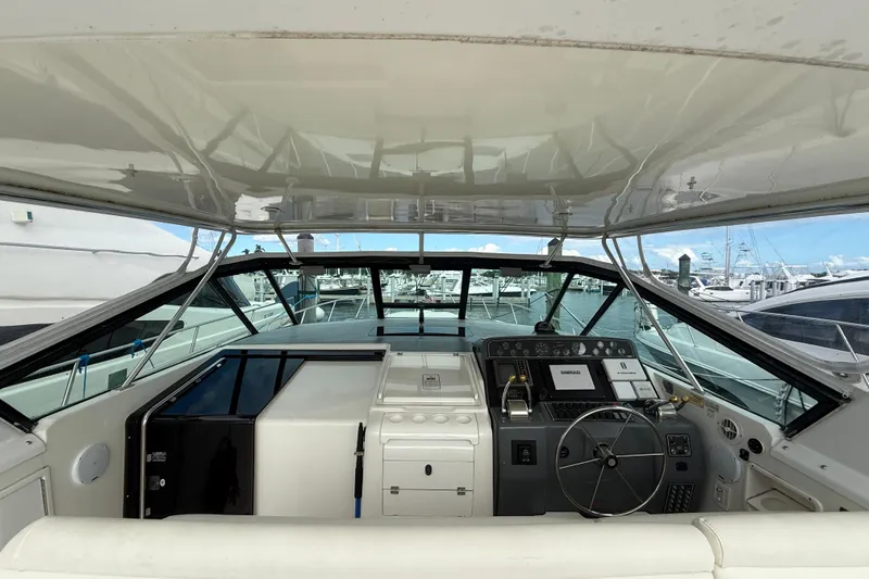  Yacht Photos Pics 1999 Tiara Yachts 4000 Express helm with modern navigation equipment and marina view.