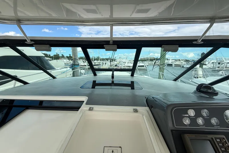  Yacht Photos Pics 1999 Tiara Yachts 4000 Express helm view with marina background.
