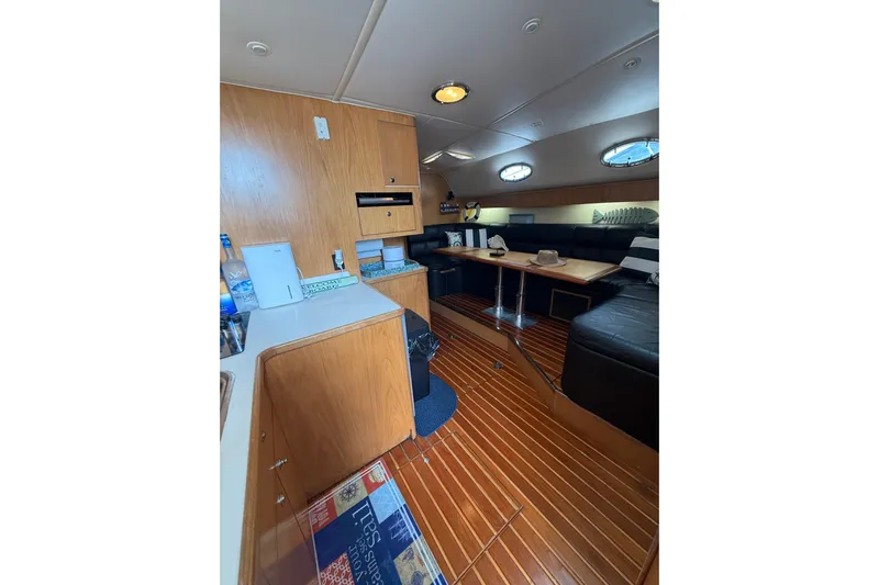  Yacht Photos Pics 1999 Tiara Yachts 4000 Express interior with wood finish and cozy seating area.