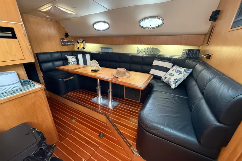  Yacht Photos Pics Interior of 1999 Tiara Yachts 4000 Express with leather seating and wooden table.