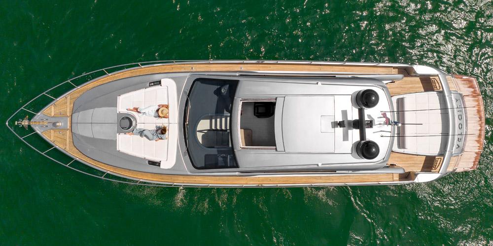 Top view of a 2015 Pershing 62' yacht on green water.
