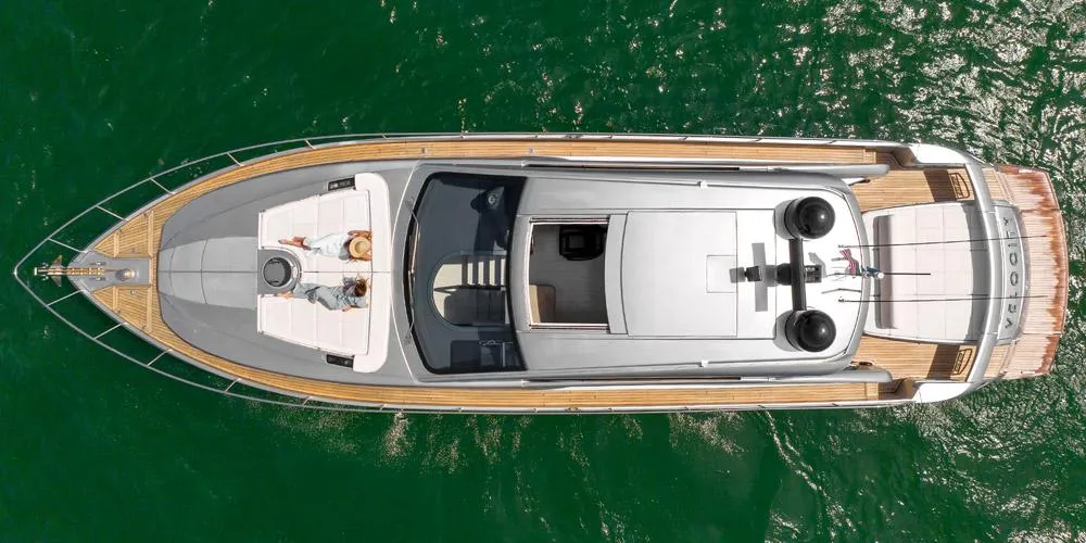Top view of a 2015 Pershing 62' yacht on green water.
