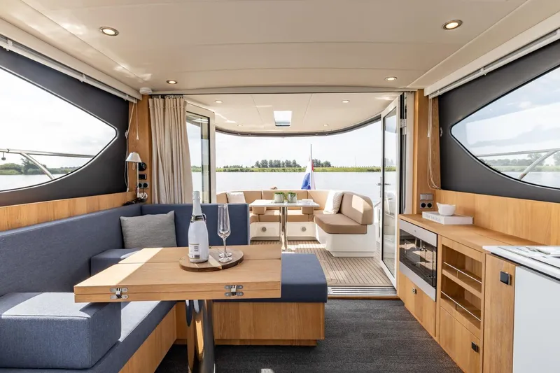  Yacht Photos Pics Luxurious interior of 2024 Vripack 42 Open Kuip yacht with elegant seating and dining area.