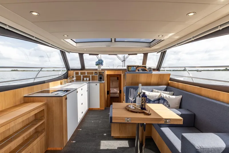  Yacht Photos Pics Luxurious interior of 2024 Vripack 42 Open Kuip yacht with modern kitchen and seating area.