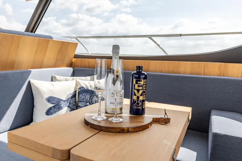  Yacht Photos Pics Luxurious interior of 2024 Vripack 42 Open Kuip yacht with champagne and glasses.