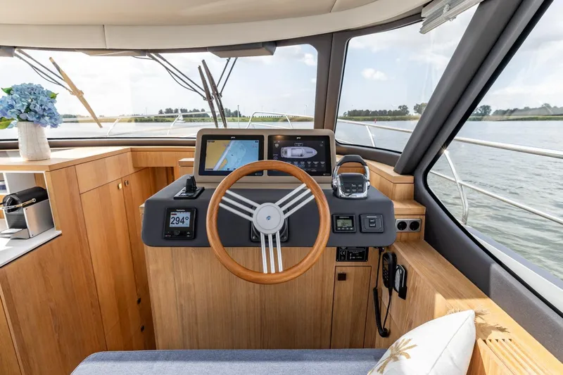  Yacht Photos Pics 2024 Vripack 42 Open Kuip yacht helm with modern navigation equipment and wooden finish.