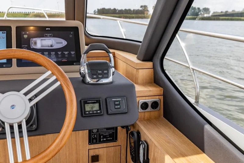  Yacht Photos Pics 2024 Vripack 42 Open Kuip yacht helm with modern controls and wooden accents.