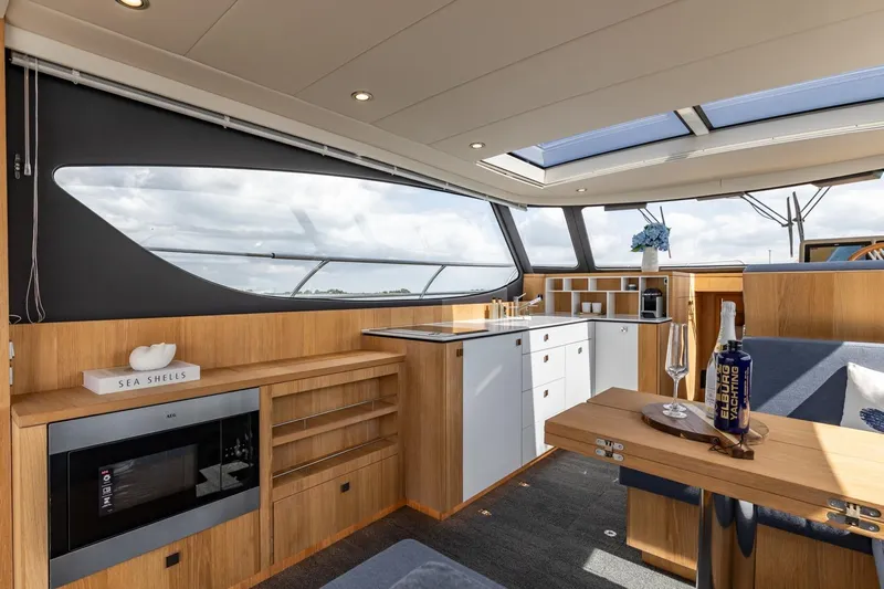  Yacht Photos Pics Luxurious interior of 2024 Vripack 42 Open Kuip yacht with modern kitchen and seating area.