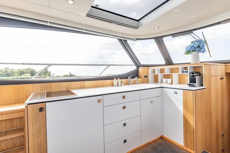  Yacht Photos Pics Luxurious interior of 2024 Vripack 42 Open Kuip yacht with modern kitchen design.