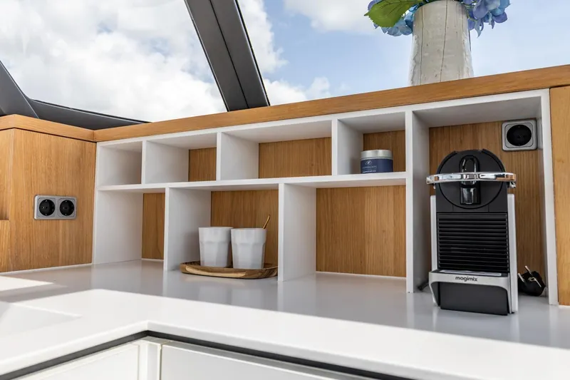  Yacht Photos Pics Modern kitchen area on 2024 Vripack 42 Open Kuip yacht with coffee machine and storage.