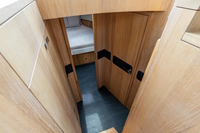  Yacht Photos Pics Interior of 2024 Vripack 42 Open Kuip yacht, featuring wooden cabinetry and cozy sleeping area.