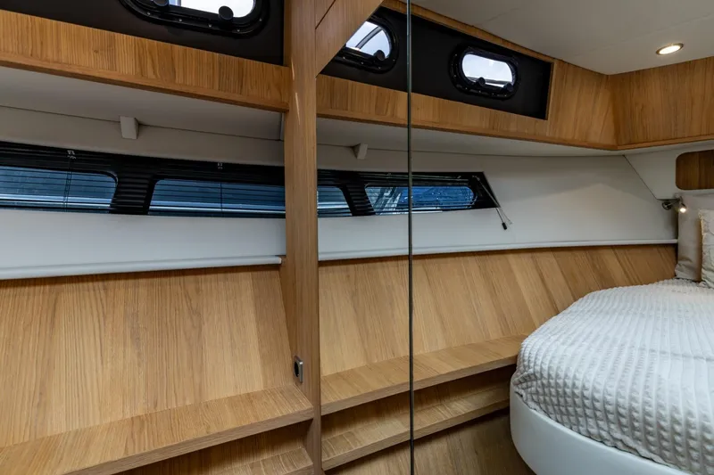  Yacht Photos Pics Luxurious interior of 2024 Vripack 42 Open Kuip yacht with wood finish and cozy bed.